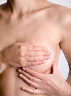 Woman holding her breast